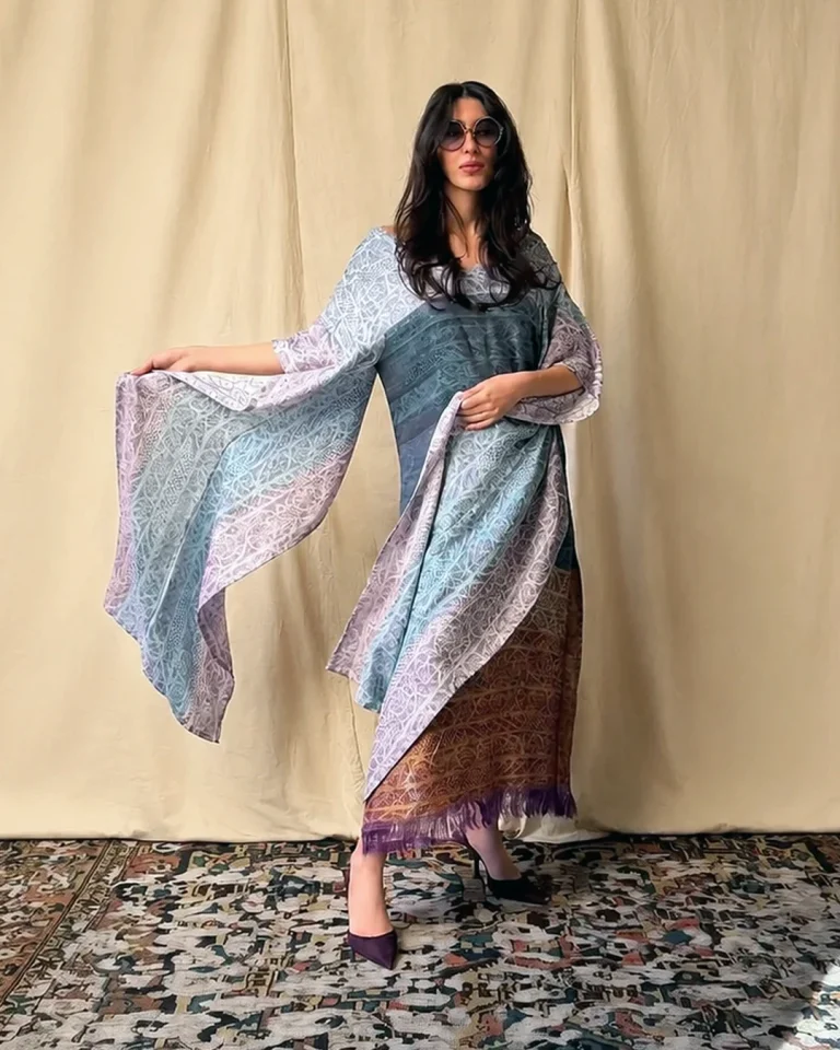 Three-quarter view of the Atlas Abaya with freely draping handwoven silk, open sides, and a golden band at the lower part of the garment