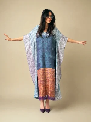 Full view of the Atlas Abaya with an elongated silhouette, patterned golden hem, and purple fringes at the lower edge