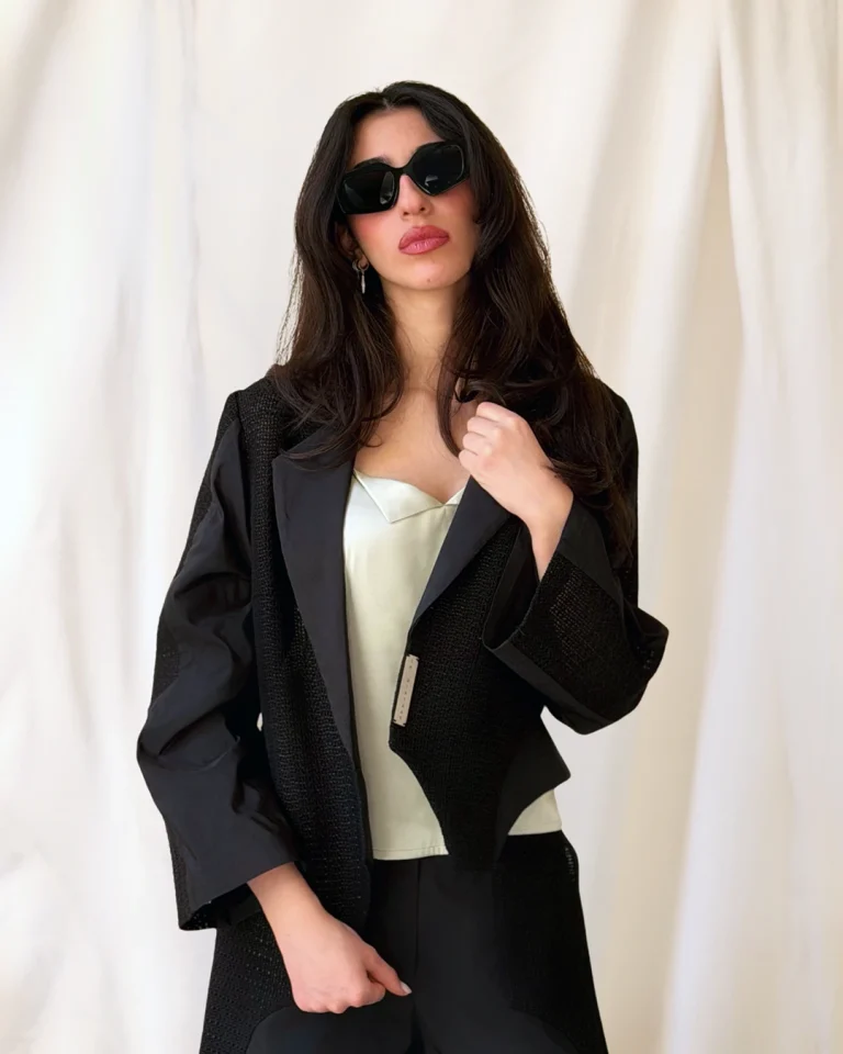 Close-up view of the Shabaq Taffeta Jacket and Trousers while adjusting the collar, emphasizing the textured and smooth fabric contrast