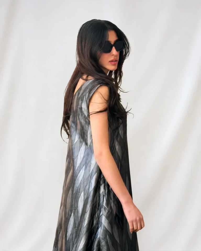 Side and back close view of the Silver Silk Dress, highlighting the sleeveless cut, waved texture, and light-reflecting surface