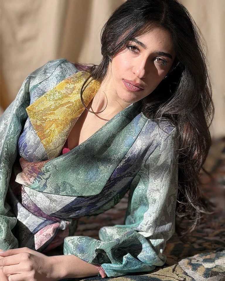 Close-up view of the Zarvan Handwoven Jacket with a wrapped collar, luminous Zari texture, and layered green, yellow, silver, and violet tones