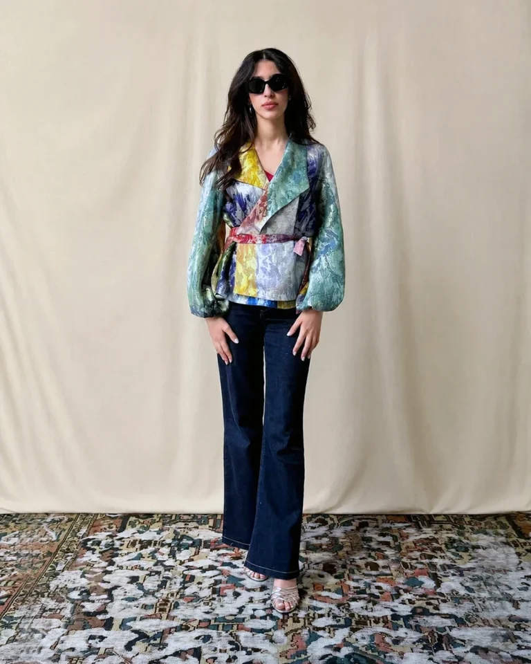 Full-length view of the Zarvan Handwoven Jacket with a belted silhouette, voluminous sleeves, layered handwoven colors, and dark trousers