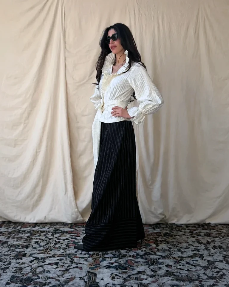 Full-length view of the Queen taffeta blouse and trousers highlighting the contrast between the light upper half and dark flowing trousers