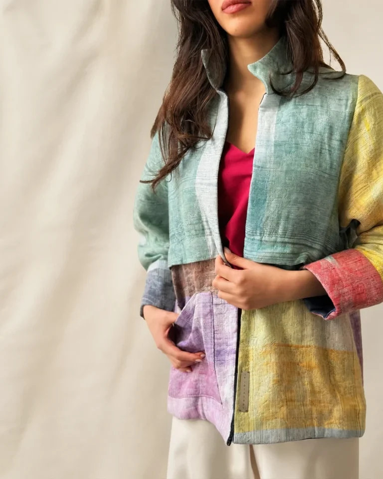 Close-up view of the Iron Jacket with a standing collar, handwoven Daraei cotton texture, and layered blue, yellow, pink, and purple tones