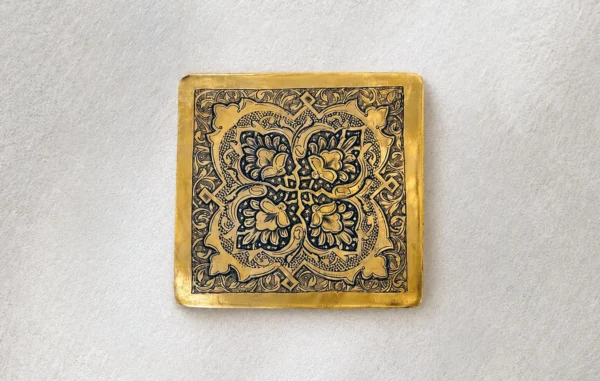 Square hand-engraved brass panel with a symmetrical floral motif and arabesque border, Isfahan qalamzani