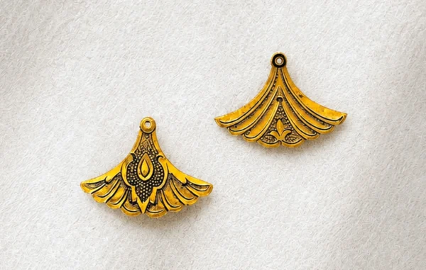 Two handcrafted fan-shaped metal ornaments with raised relief and fine dotwork, Isfahan engraving